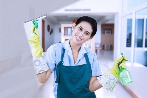 Cleaner maintaining lift lobby and touchpoints in a communal area
