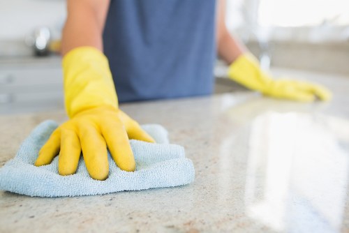 Professional cleaner in Ilford using appropriate protective equipment